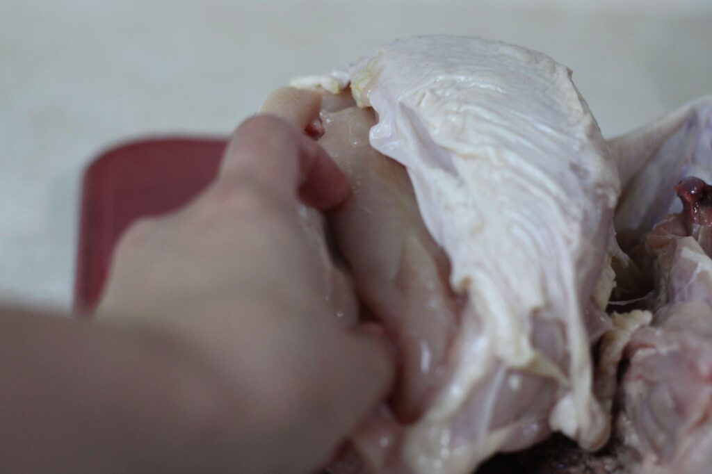 raw chicken being carved 