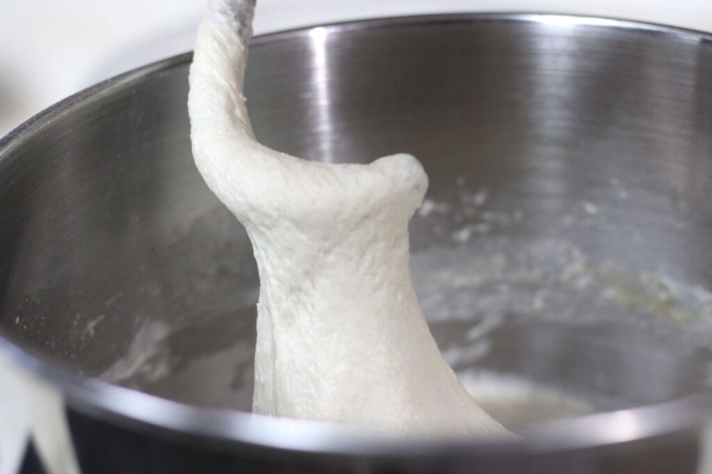 sourdough cinnamon roll dough on kitchen aid dough hook attachment 